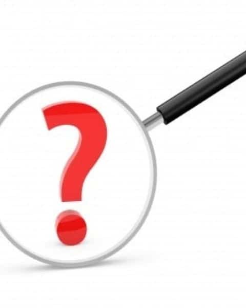 A magnifying glass with a big red question mark in the center.