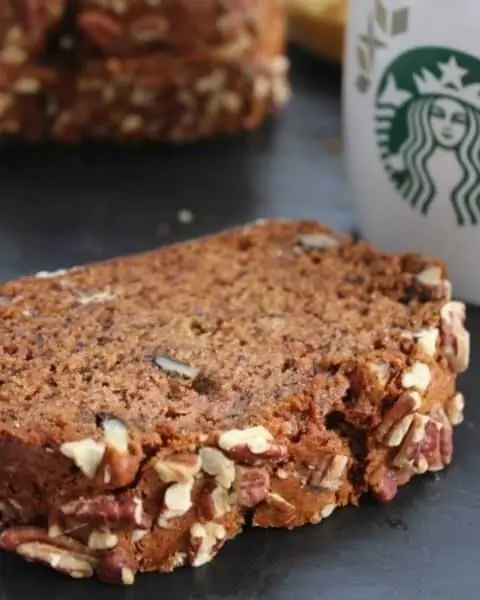 Copycat Starbucks banana nut bread with a cup of Starbucks drink.