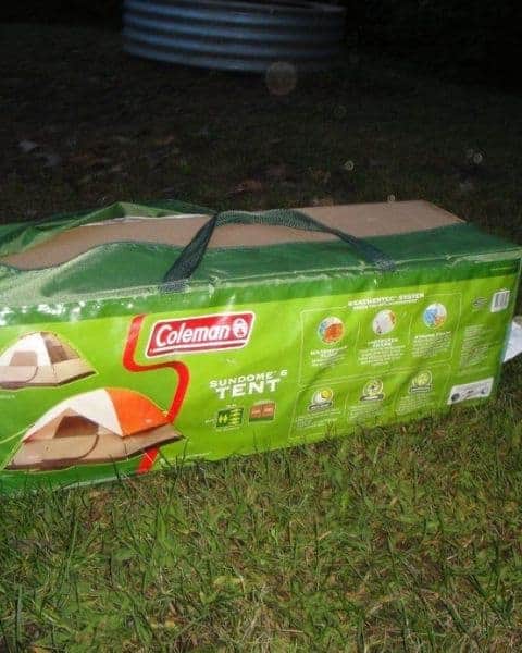 Coleman camping tent in the middle of the grass field.