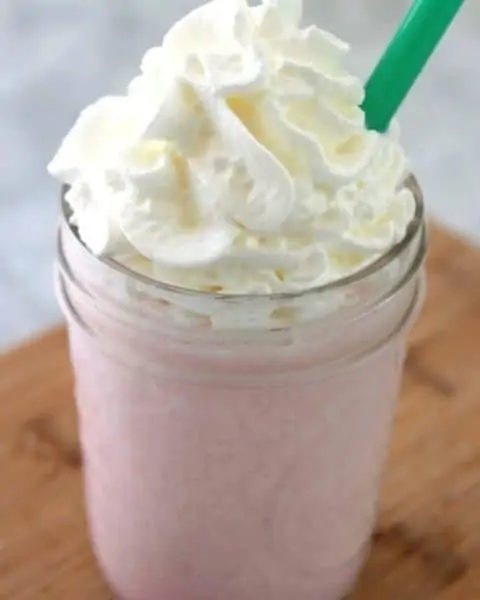 Cotton candy frap with whip cream in a mason jar.