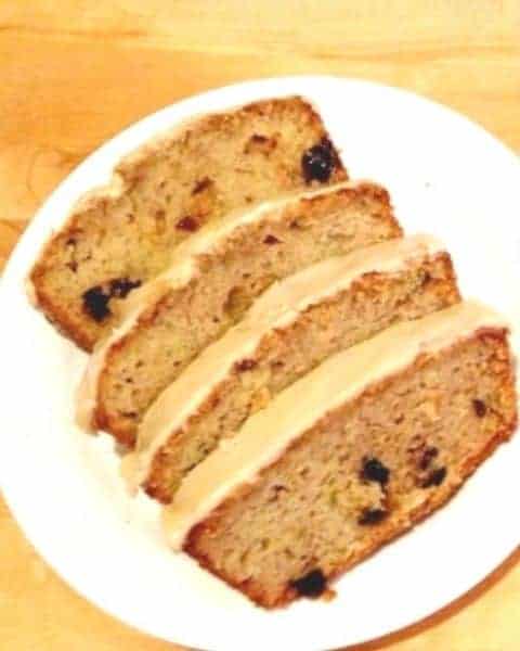 Several slices of cranberry zucchini bread with a glazed frosting on top.