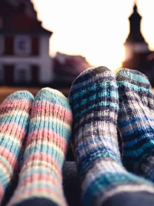 Two people wearing cozy woolen socks watching a movie.