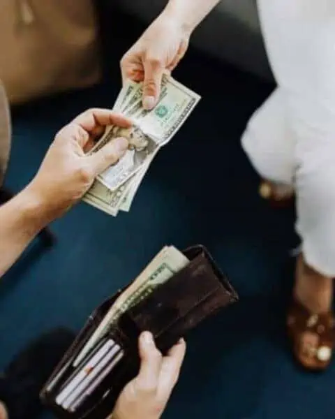 Money exchanging hands between two people.