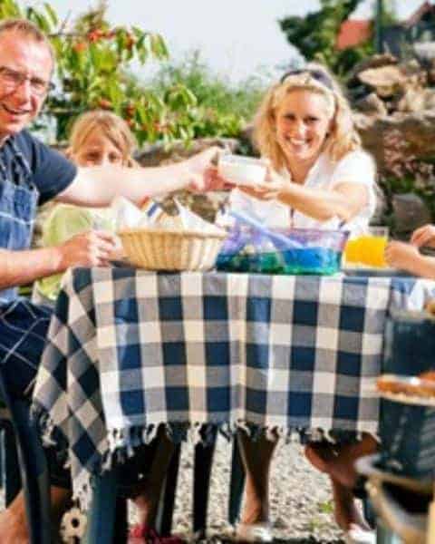 A family eating together outside in the garden.