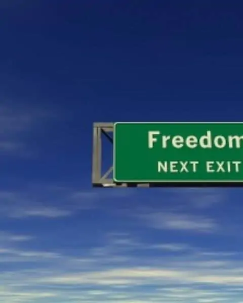 A sign that reads "Freedom Next Exit."