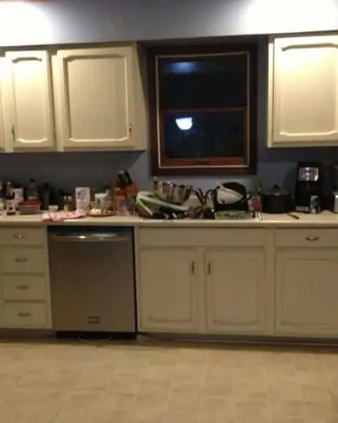 An overview of kitchen counter and sink with food and dishes to prepare for meals.