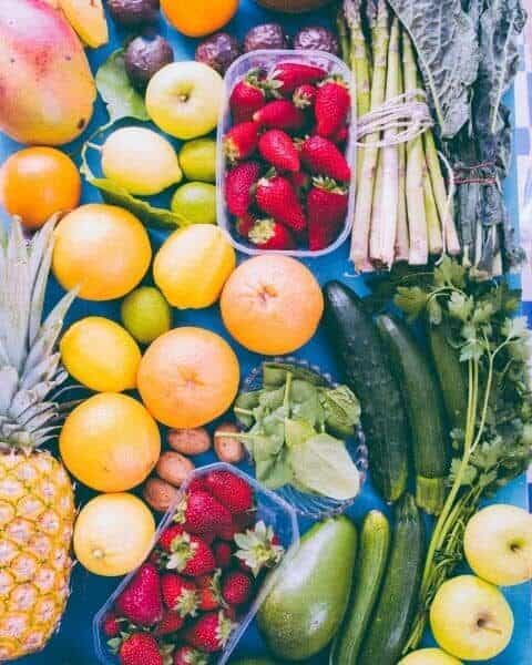 A variety of garden produce, including strawberries, oranges, lemons, cucumbers, apples, and more.