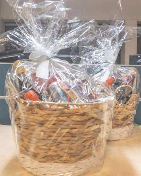 Wicker baskets wrapped in plastic for gifts.