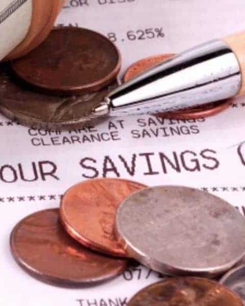 Pennies and pen on top of a receipt.