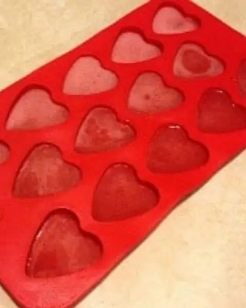 Silicone cup holders with gummy heart shaped candies.