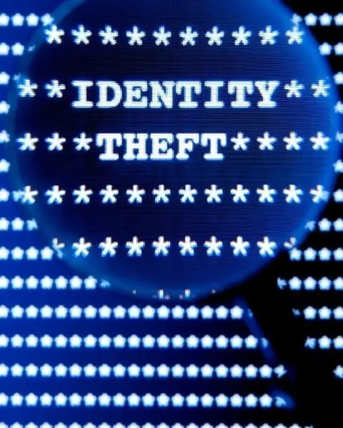 Magnifying glass featuring the words, "identity theft."