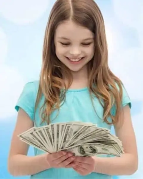 A little girl holding a stack of money.