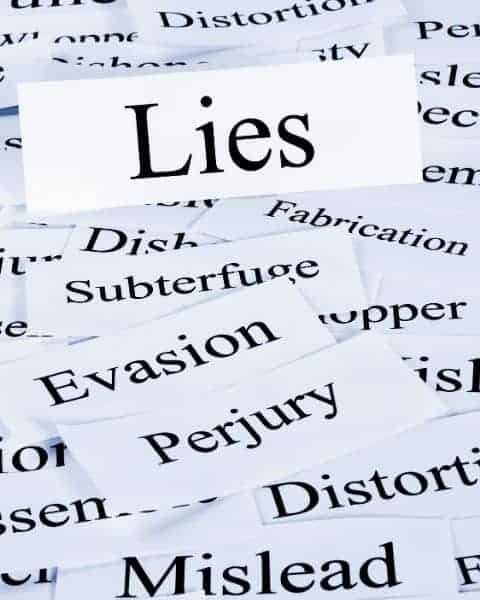 Pieces of paper with words that describe poor money management habits.