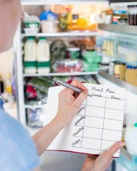 A woman planning her menu with the food she has at home.