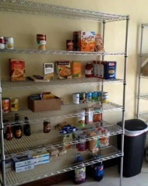 A variety of canned and boxed foods on shelves in the garage for food storage.