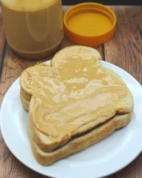 Peanut Butter spread on a slice of bread.