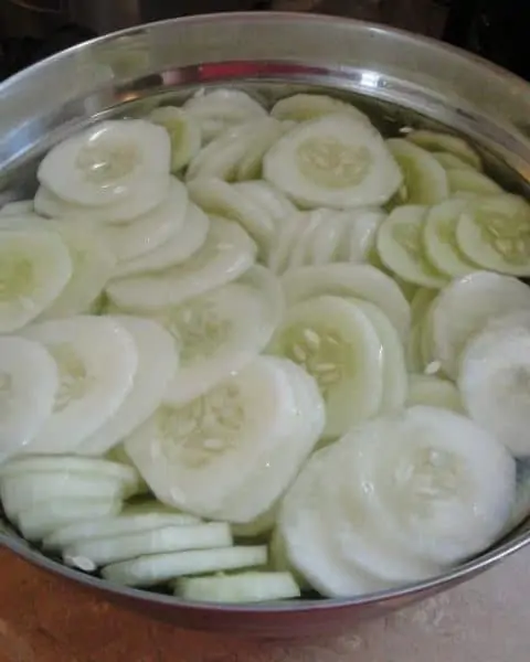 A pot of sliced and peeled cucumbers.