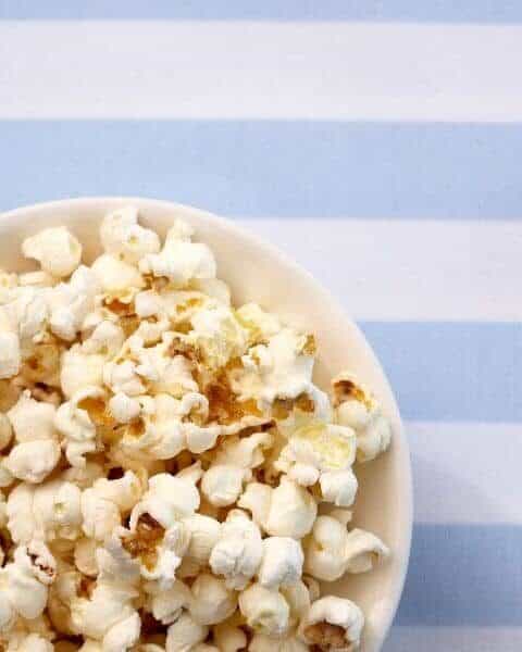 A white bowl of popcorn.