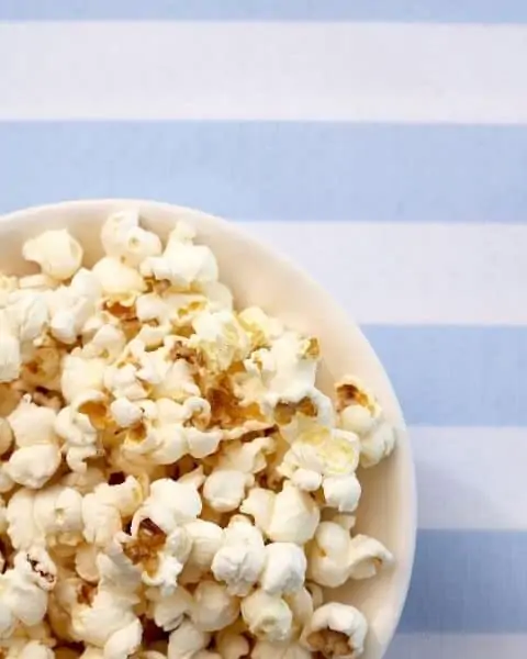 A white bowl of popcorn.