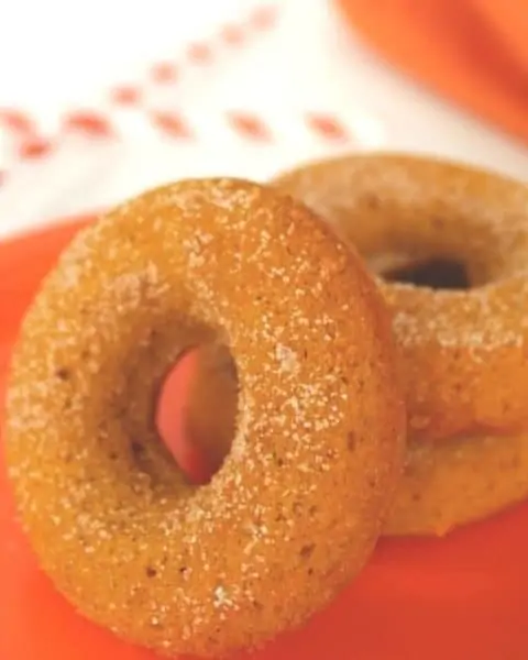 Pumpkin flavor donuts sprinkled with sugar.