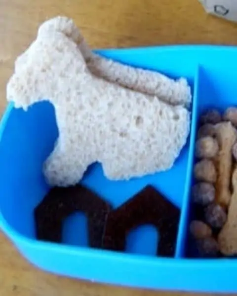Bread cut out in the shape of dogs for a puppy themed lunch.