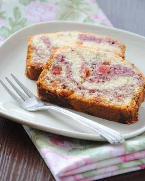 Freshly baked Copycat Starbucks Raspberry Swirl Pound Cake Recipe slices on a white plate and silver fork.