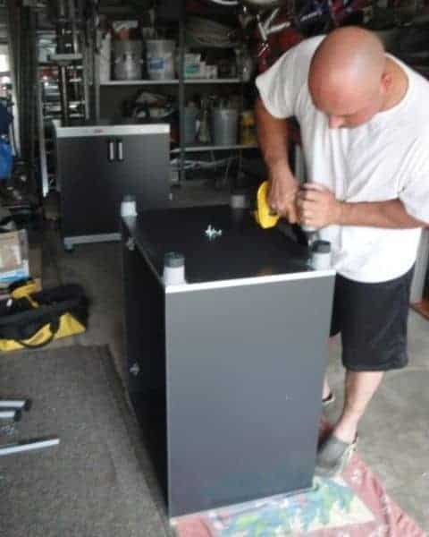 A man working on a table with tools.