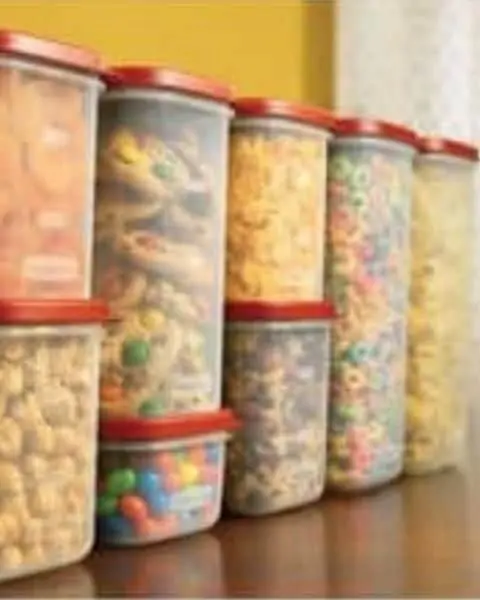 A variety of tupperware sizes full of homemade treats, cereals, and other food.