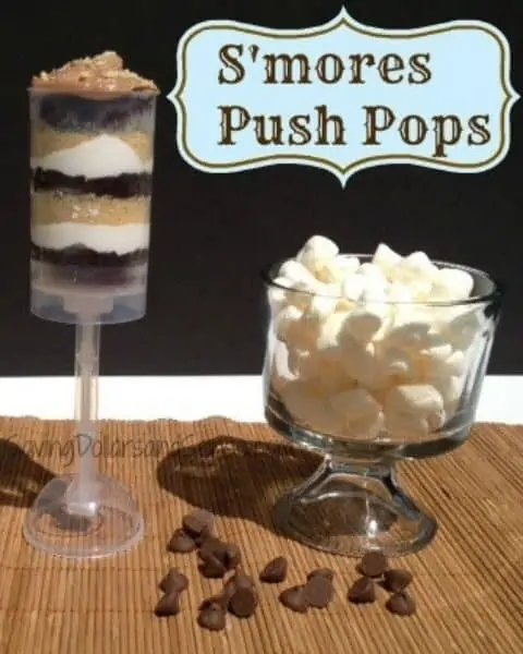 Homemade push pops with smores incredients, including chocolate chips, marshmallows, graham crackers, and chocolate pudding.