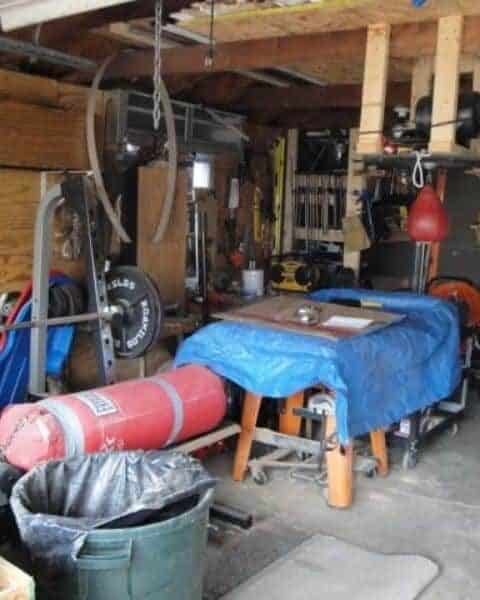 An overview of a home's garage including tools and gym equipment.