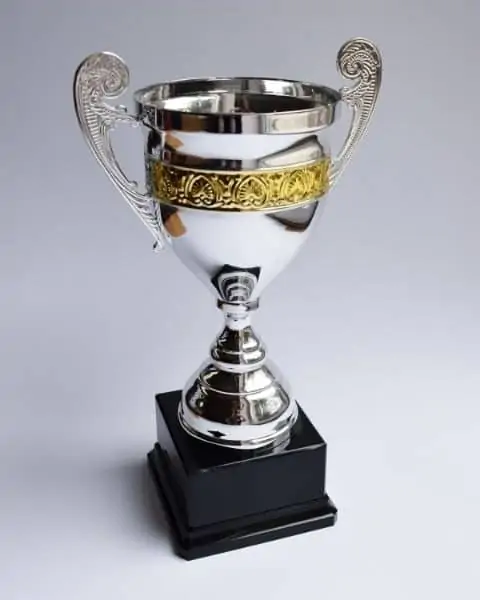 A silver trophy with a gold outline to award prizes.