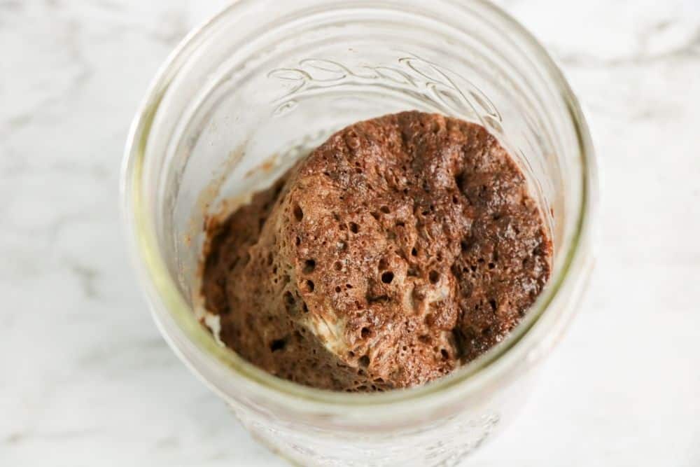 Chocolate mug cake ingredients all mixed together in a mason jar. 