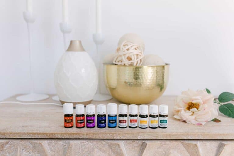 A display of Young Living essential oils lined up on a table.