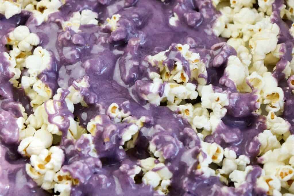 Kool-Aid sugar sauce poured over top of baked popcorn. 