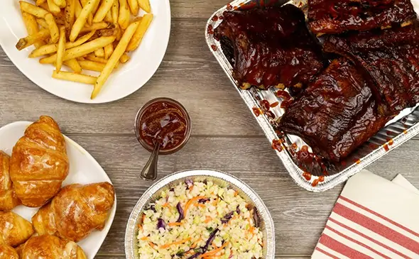 Baby back ribs, rolls, fries, and coleslaw. 