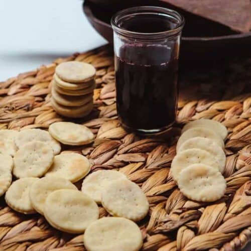 Communion wafers scattered on a wicker board.