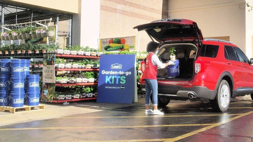 SUV with back hatch open at Lowes grabbing a garden-to-go kit.
