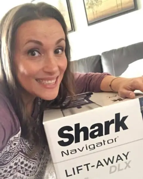 A woman with her Shark Navigator vacuum.