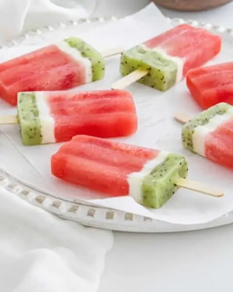 Homemade watermelon popsicles with kiwi, watermelon, and cream.