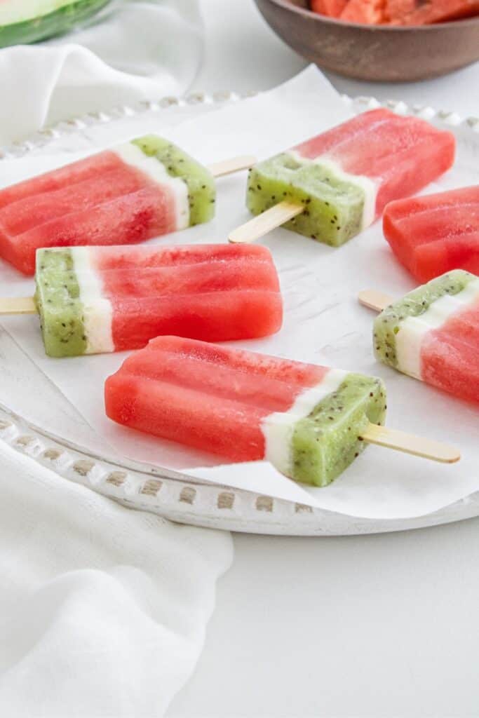 A plate full of watermelon popsicles.