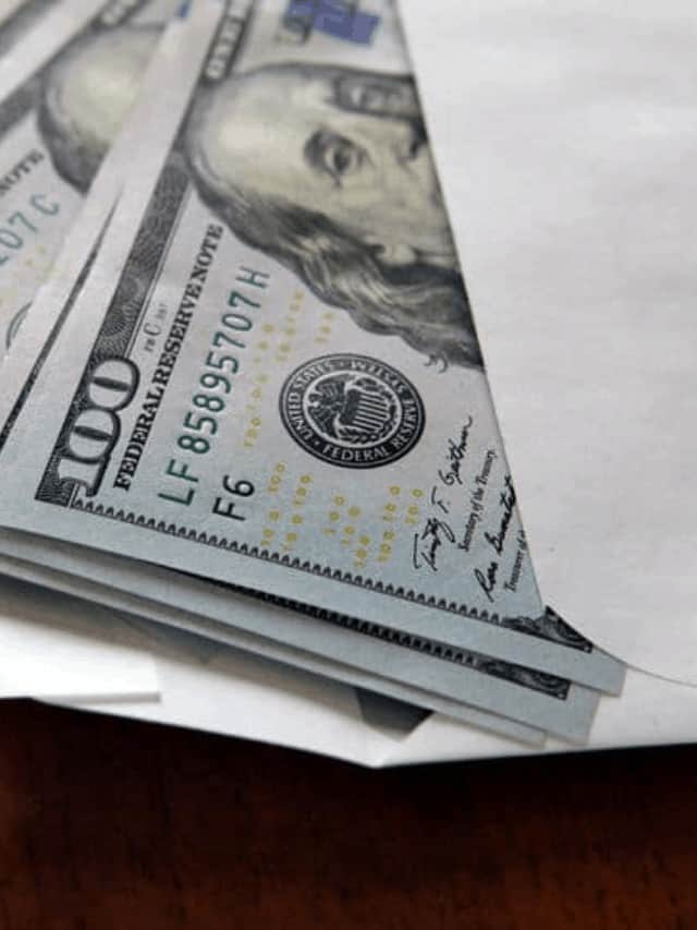 An envelope full of 100 dollar bills.