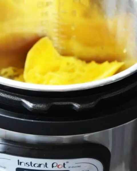 An instant pot with a spaghetti squash inside.