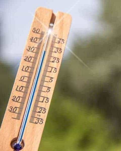 A thermometer gaging the temperature outside.
