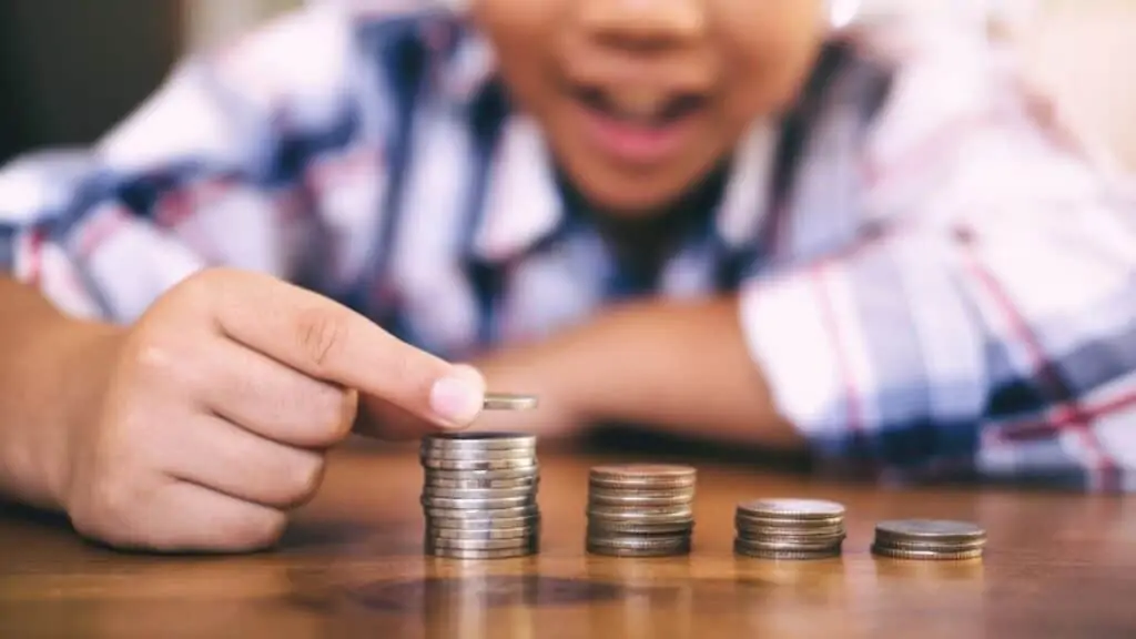 A child stacking coins.