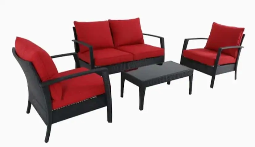 A red set of outdoor furniture of couch, table, and chairs.