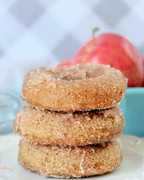 Cooked apple cider donuts with sprinkled sugar.