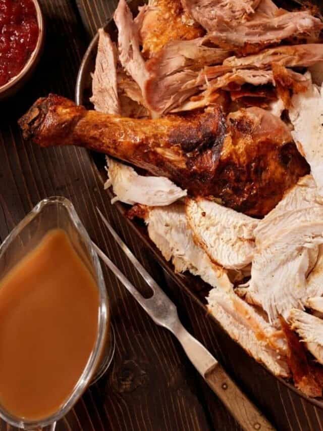 A platter of cooked turkey and other Thanksgiving dishes.