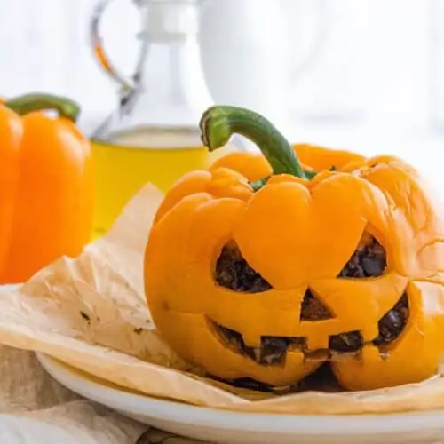 Halloween themed stuffed pepper that's shaped like a pumpkin.