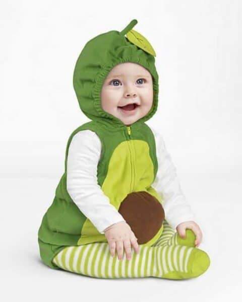 A little baby dressed as an avocado.