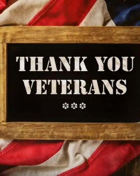Thank you veterans sign on top of an American flag.
